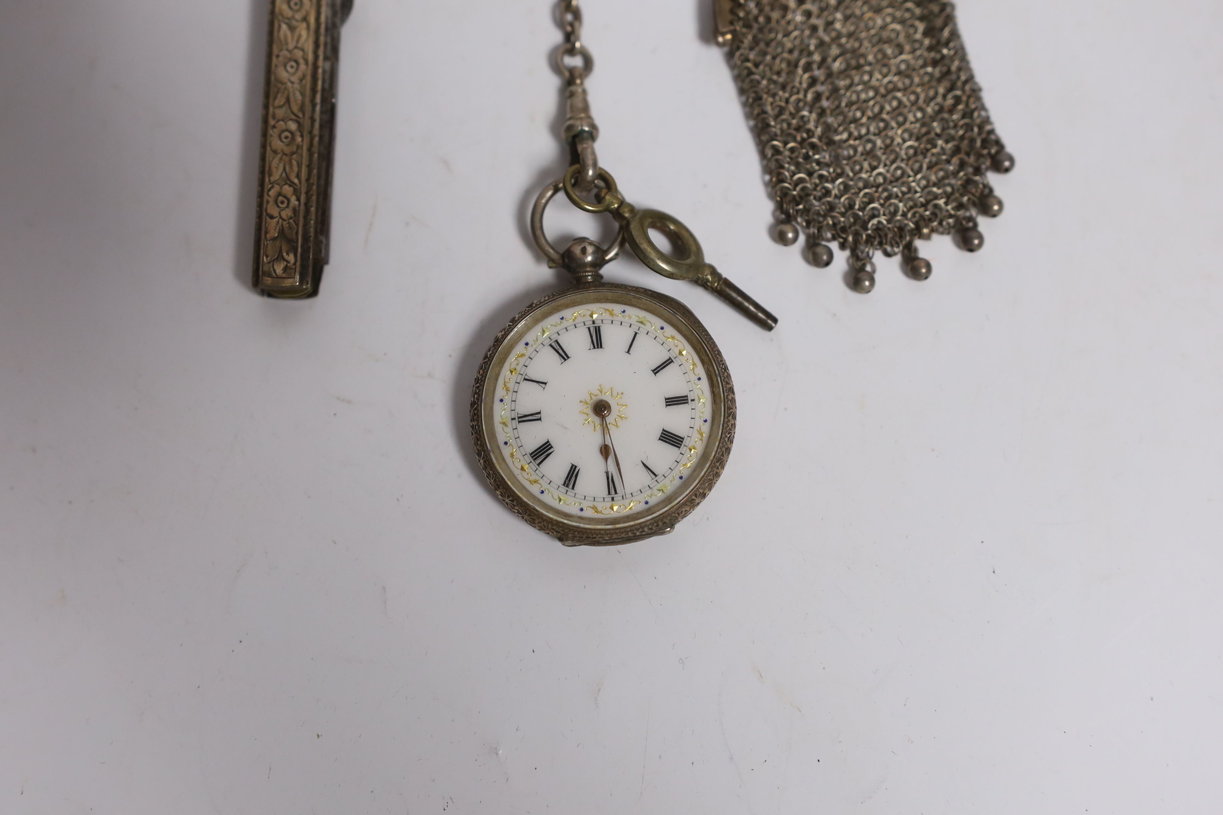 A late Victorian pierced silver chatelaine by Levi & Salaman, Birmingham, 1900, hung with three assorted accoutrements to include an unmarked mesh purse, pocket knife with button hook and a Swiss 935 fob watch, overall 2